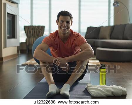 Portrait of Young man exercising at home View Large Photo Image Stock Photo - Portrait of Young man exercising at home. Fotosearch