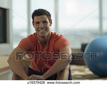 Portrait of Young man exercising at home View Large Photo Image Stock Photo - Portrait of Young man exercising at home. Fotosearch