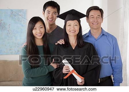 Portrait of young man in graduation gown with family View Large Photo Image Stock Photo - Portrait of young man in graduation gown with family. Fotosearch