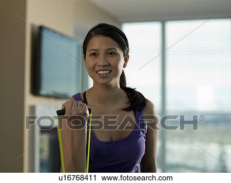 Portrait of Young woman exercising at home View Large Photo Image Stock Image - Portrait of Young woman exercising at home. Fotosearch
