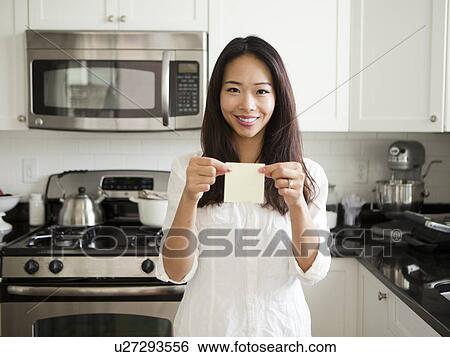 Portrait of young woman holding adhesive note View Large Photo Image Stock Photograph - Portrait of young woman holding adhesive note . Fotosearch
