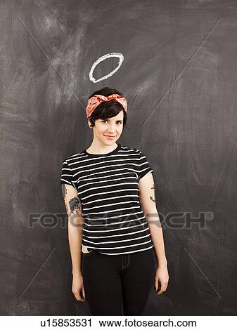 Portrait of young woman in front of blackboard View Large Photo Image Stock Image - Portrait of young woman in front of blackboard. Fotosearch