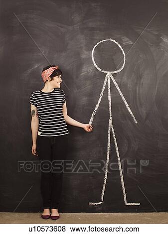 Portrait of young woman in front of blackboard View Large Photo Image Stock Photo - Portrait of young woman in front of blackboard. Fotosearch