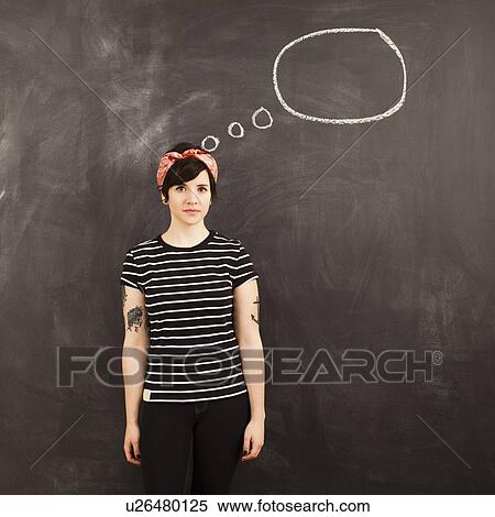 Portrait of young woman in front of blackboard View Large Photo Image Stock Photography - Portrait of young woman in front of blackboard. Fotosearch