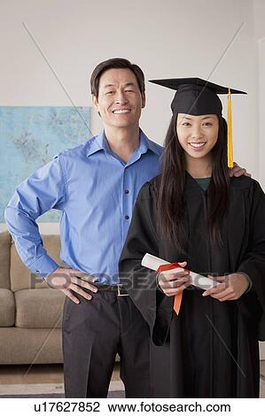 Portrait of young woman in graduation gown with mother and brother View Large Photo Image Stock Image - Portrait of young woman in graduation gown with mother and brother. Fotosearch
