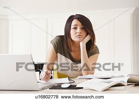 Portrait of young woman learning at home View Large Photo Image Stock Photo - Portrait of young woman learning at home. Fotosearch