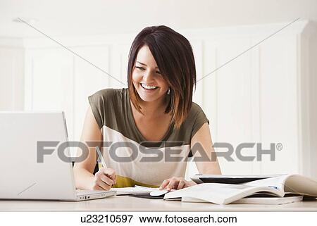 Portrait of young woman learning at home View Large Photo Image Stock Photo - Portrait of young woman learning at home. Fotosearch