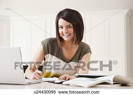 Portrait of young woman learning at home View Large Photo Image Stock Photography - Portrait of young woman learning at home. Fotosearch