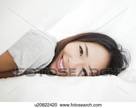 Portrait of young woman lying down View Large Photo Image Stock Image - Portrait of young woman lying down. Fotosearch