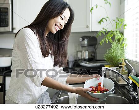 Portrait of young woman washing strawberries View Large Photo Image Stock Image - Portrait of young woman washing strawberries. Fotosearch