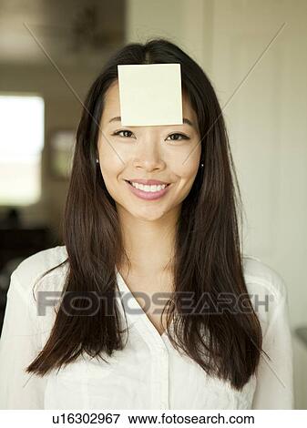 Portrait of young woman with adhesive note stuck to her forehead View Large Photo Image Stock Photo - Portrait of young woman with adhesive note stuck to her forehead. Fotosearch