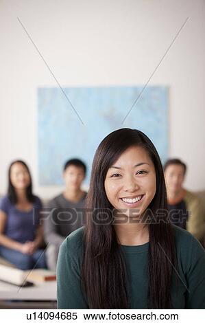 Portrait of young woman with family in background View Large Photo Image Stock Photography - Portrait of young woman with family in background. Fotosearch