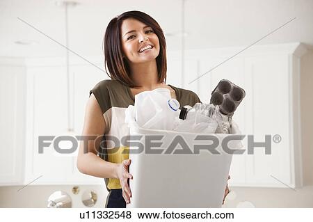 Portrait of young woman with waste bin View Large Photo Image Stock Photo - Portrait of young woman with waste bin. Fotosearch