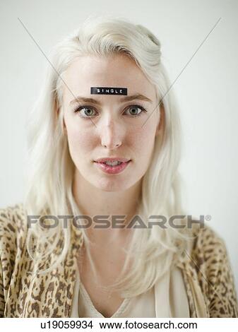 Portrait of young woman with word single on forehead View Large Photo Image Picture - Portrait of young woman with word single on forehead. Fotosearch