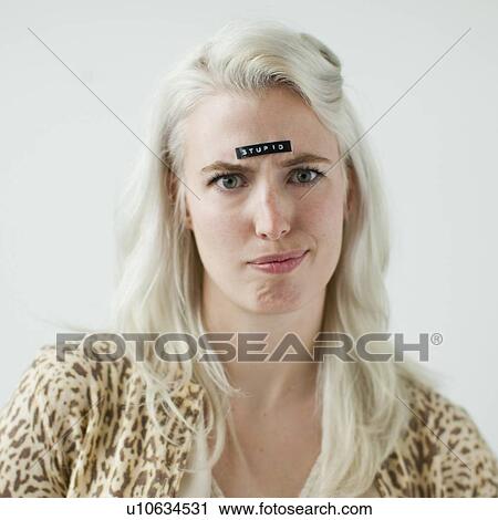 Portrait of young woman with word stupid on forehead View Large Photo Image Stock Image - Portrait of young woman with word stupid on forehead. Fotosearch