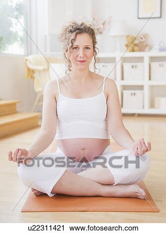 Pregnant woman practicing yoga View Large Photo Image Stock Image - Pregnant woman practicing yoga. Fotosearch