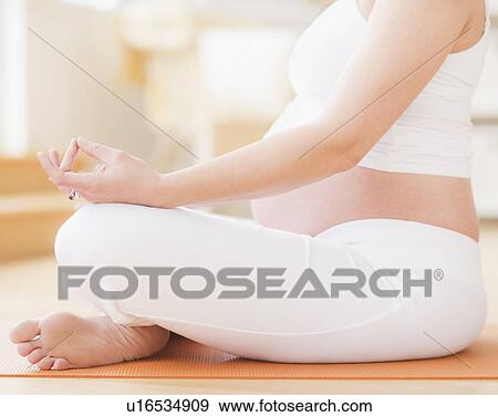 Pregnant woman practicing yoga View Large Photo Image Stock Photo - Pregnant woman practicing yoga. Fotosearch