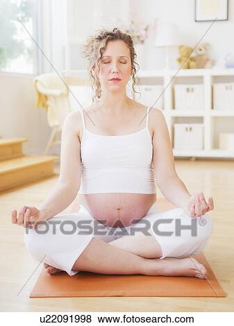 Stock Photo - Pregnant woman practicing yoga. Fotosearch