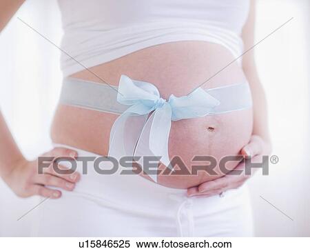 Pregnant woman with blue ribbon on her belly View Large Photo Image Stock Photography - Pregnant woman with blue ribbon on her belly. Fotosearch