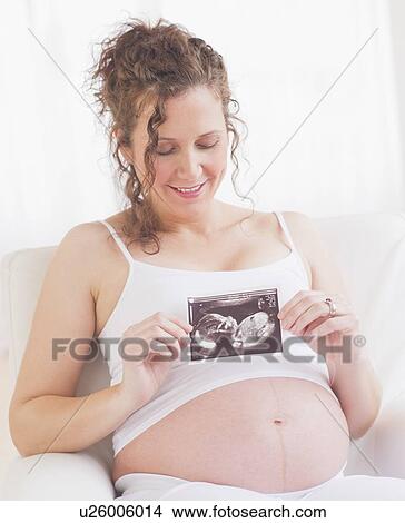 Pregnant woman with ultrasonography scan View Large Photo Image Picture - Pregnant woman with ultrasonography scan. Fotosearch