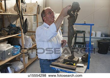 Retired man working on sculpture View Large Photo Image Stock Photo - Retired man working on sculpture. Fotosearch