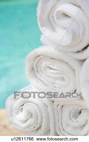 Rolled up towels in front of water View Large Photo Image Stock Photograph - Rolled up towels in front of water. Fotosearch