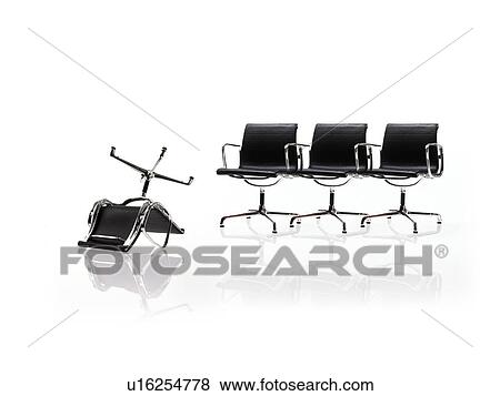 Stock Photo - Row of corporate chairs, one upside down. Fotosearch
