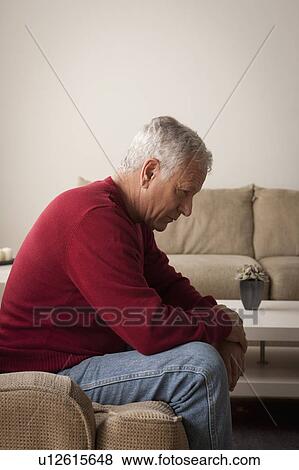 Sad senior man sitting on armchair View Large Photo Image Stock Photo - Sad senior man sitting on armchair. Fotosearch