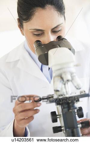 Scientist looking through microscope View Large Photo Image Stock Image - Scientist looking through microscope. Fotosearch
