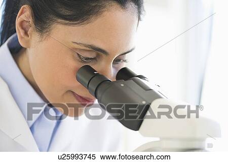 Stock Photography - Scientist looking through microscope. Fotosearch