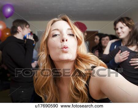 Stock Image - Self portrait of young woman at party. Fotosearch