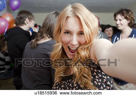 Self portrait of young woman at party View Large Photo Image Stock Photograph - Self portrait of young woman at party. Fotosearch