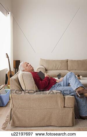 Stock Photo - Senior man sleeping on armchair. Fotosearch