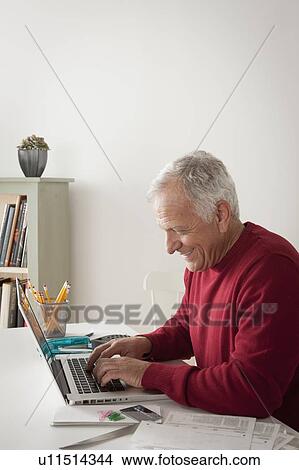 Picture - Senior man using laptop. Fotosearch