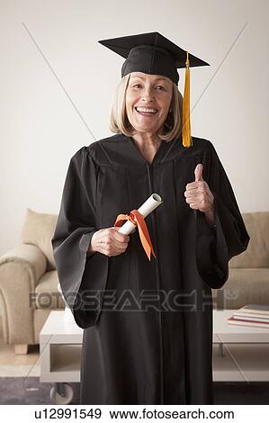 Senior woman wearing graduation gown View Large Photo Image Stock Photo - Senior woman wearing graduation gown. Fotosearch