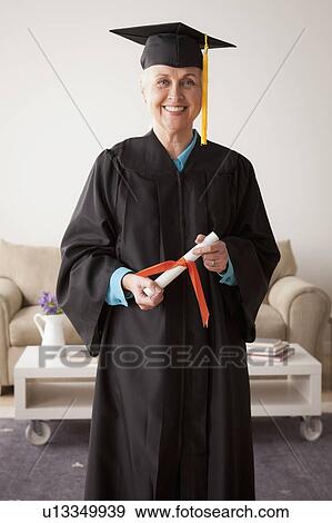 Senior woman wearing graduation gown View Large Photo Image Stock Photo - Senior woman wearing graduation gown. Fotosearch