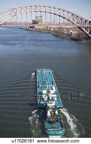 Stock Image - Ship under bridge. Fotosearch