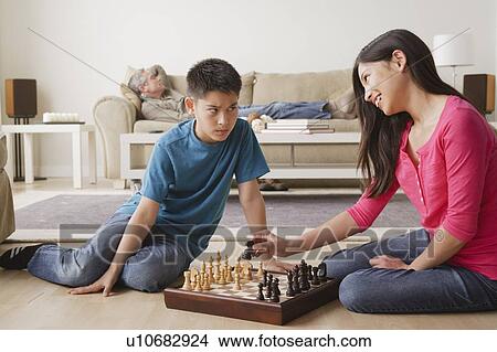 Siblings playing chess game View Large Photo Image Picture - Siblings playing chess game. Fotosearch