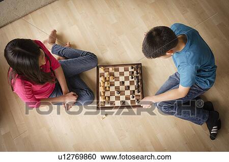 Siblings playing chess game View Large Photo Image Stock Image - Siblings playing chess game. Fotosearch