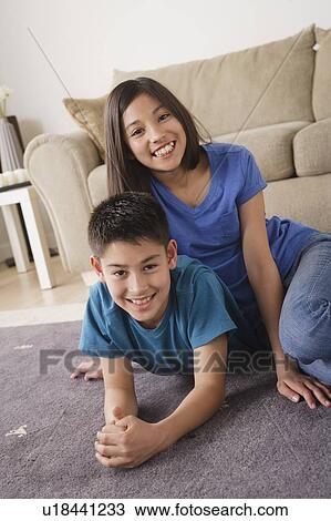 Stock Image - Sister and brother smiling. Fotosearch