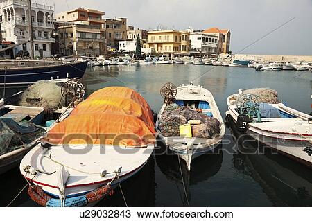 Stock Image - Small boats moored in local harbour. Fotosearch