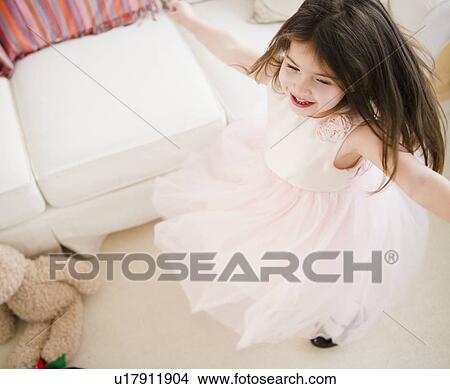 Small girl (4-5 years) dancing in tulle dress View Large Photo Image Picture - Small girl (4-5 years) dancing in tulle dress. Fotosearch