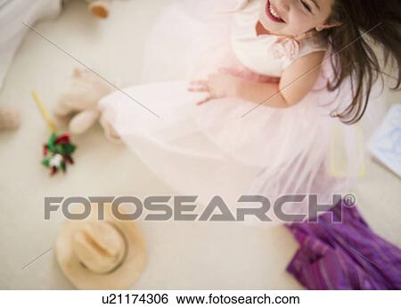 Stock Photograph - Small girl (4-5 years) dancing in tulle dress. Fotosearch