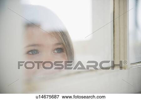 Small girl (4-5 years) looking through window View Large Photo Image Stock Photo - Small girl (4-5 years) looking through window. Fotosearch