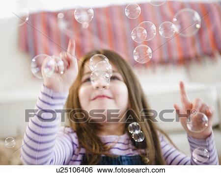 Small girl (4-5 years) playing with bubbles View Large Photo Image Stock Photograph - Small girl (4-5 years) playing with bubbles. Fotosearch
