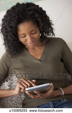 Smiling mid adult woman using digital tablet View Large Photo Image Stock Image - Smiling mid adult woman using digital tablet. Fotosearch