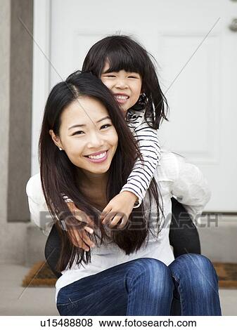 Smiling woman embracing by her daughter (4-5) View Large Photo Image Stock Photo - Smiling woman embracing by her daughter (4-5). Fotosearch