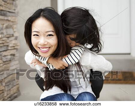 Smiling woman embracing by her daughter (4-5) View Large Photo Image Stock Photo - Smiling woman embracing by her daughter (4-5). Fotosearch