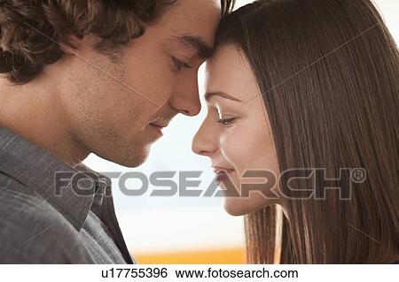 Stock Photograph - Smiling young couple together. Fotosearch
