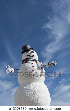 Stock Image - Snowman under blue sky. Fotosearch